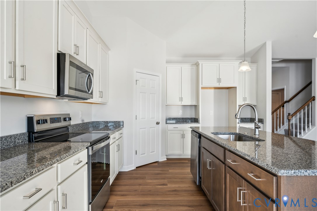 115 Logan Way Tappahannock, VA 22560 - Photo 7 of 29 a kitchen with stainless steel appliances granite countertop a sink stove and refrigerator