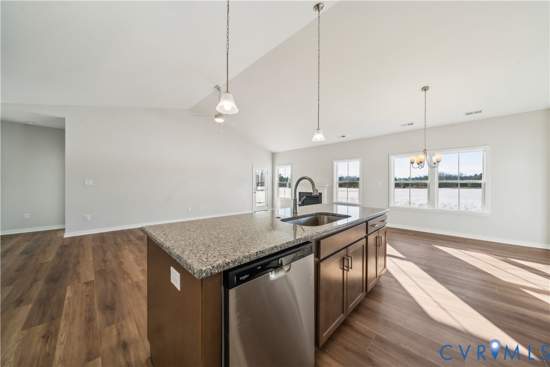 115 Logan Way Tappahannock, VA 22560 - Photo 10 of 29 a kitchen with stainless steel appliances granite countertop a sink a stove and a wooden floors