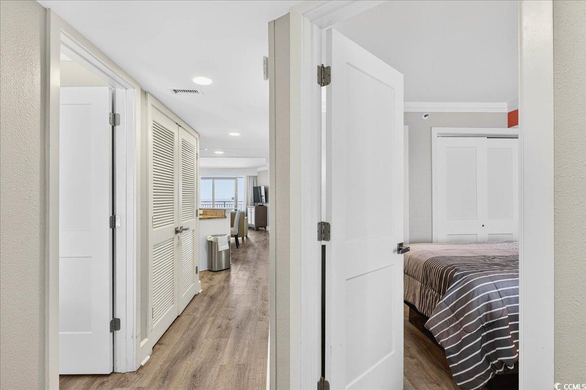 7200 North Ocean Boulevard, Unit 1155 Myrtle Beach, SC 29572 - Photo 14 of 40 Corridor featuring wood finished floors, crown molding, and recessed lighting