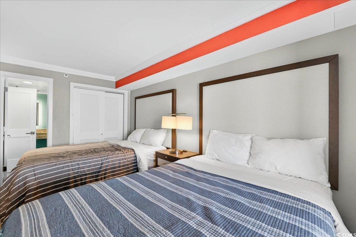 7200 North Ocean Boulevard, Unit 1155 Myrtle Beach, SC 29572 - Photo 16 of 40 Bedroom with a closet and ornamental molding