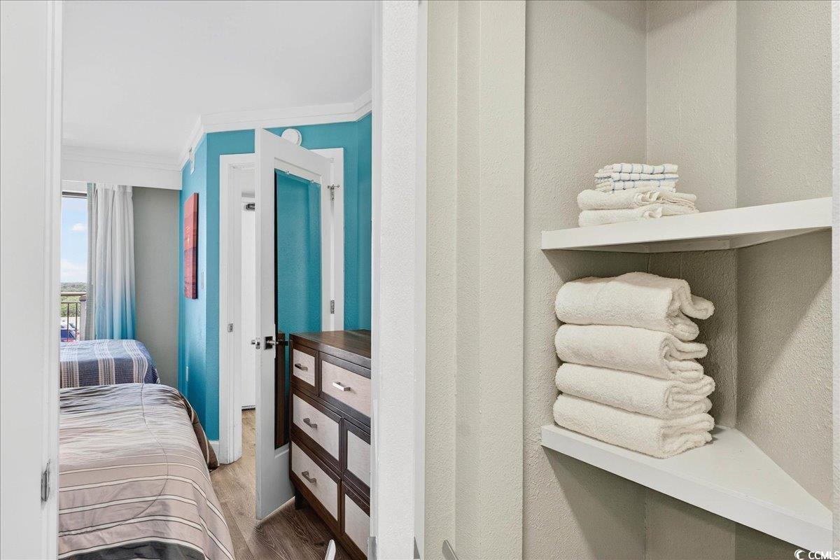 7200 North Ocean Boulevard, Unit 1155 Myrtle Beach, SC 29572 - Photo 19 of 40 Bedroom with ornamental molding and wood finished floors