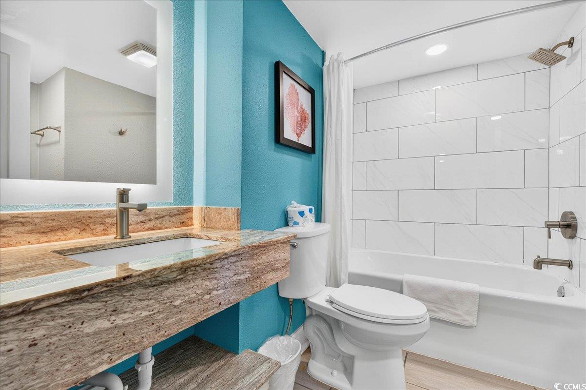 7200 North Ocean Boulevard, Unit 1155 Myrtle Beach, SC 29572 - Photo 20 of 40 Full bath featuring shower / tub combo and wood finished floors