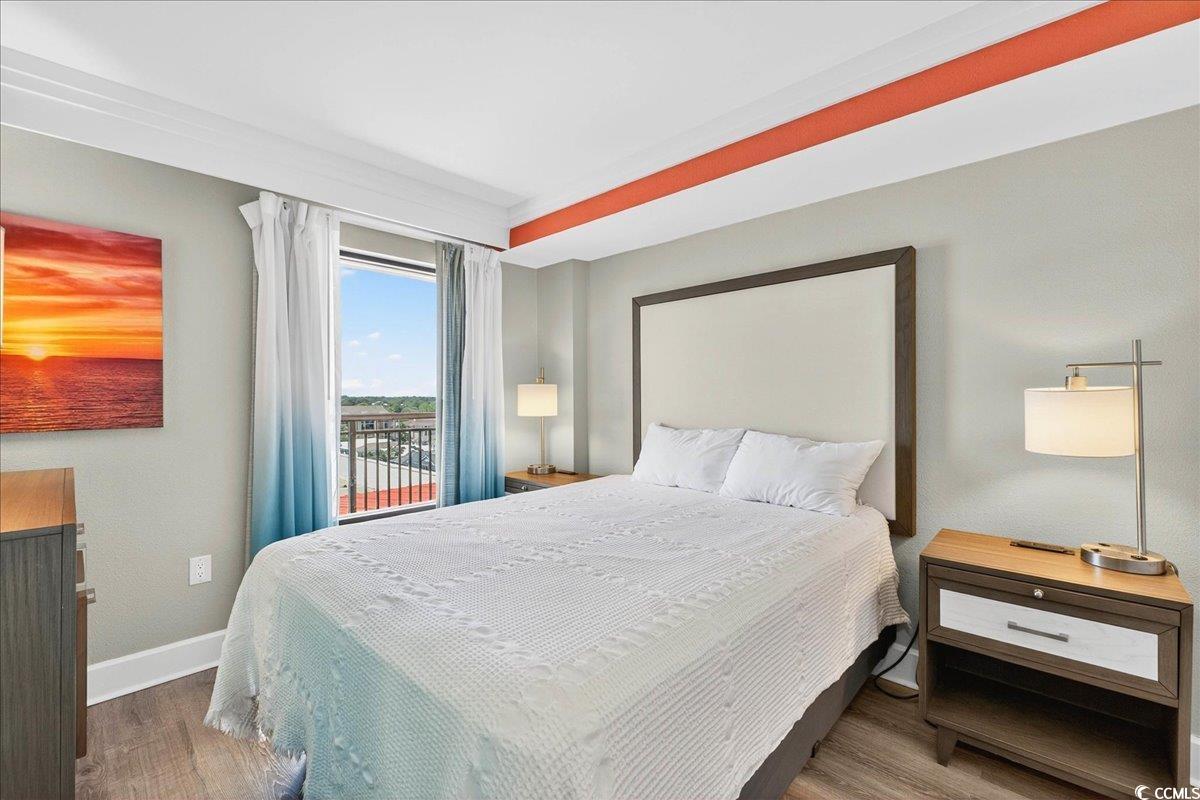 7200 North Ocean Boulevard, Unit 1155 Myrtle Beach, SC 29572 - Photo 21 of 40 Bedroom with wood finished floors and baseboards