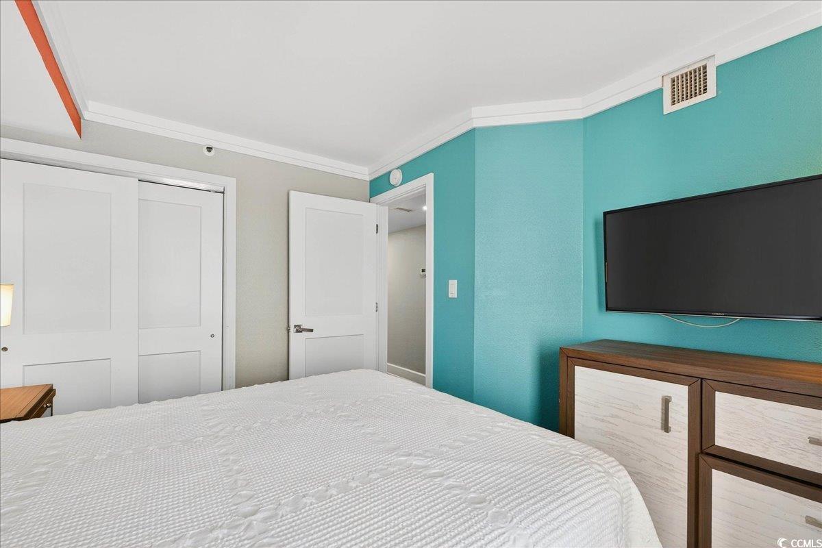 7200 North Ocean Boulevard, Unit 1155 Myrtle Beach, SC 29572 - Photo 23 of 40 Bedroom with a closet and crown molding