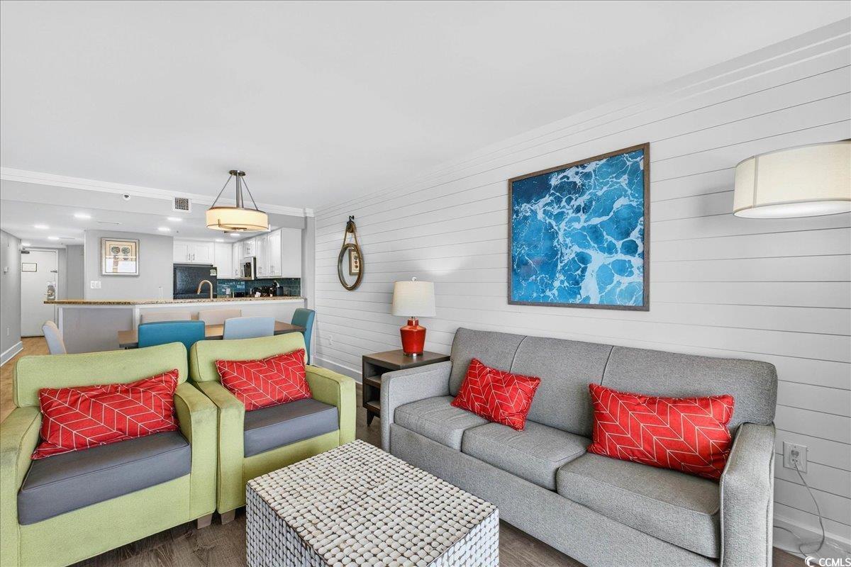 7200 North Ocean Boulevard, Unit 1155 Myrtle Beach, SC 29572 - Photo 35 of 40 Living room with dark wood finished floors, wood walls, and recessed lighting