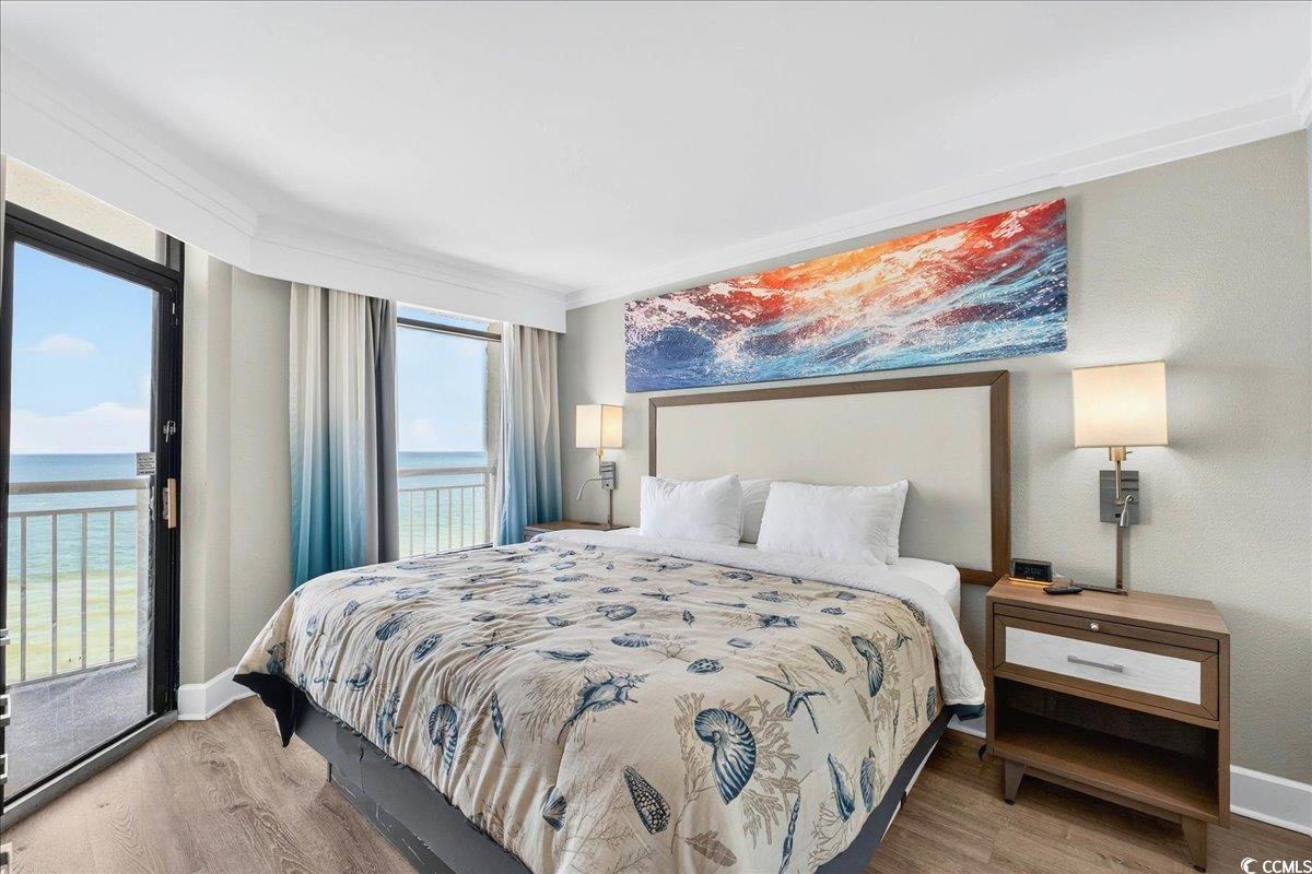 7200 North Ocean Boulevard, Unit 1155 Myrtle Beach, SC 29572 - Photo 36 of 40 Bedroom featuring a water view, wood finished floors, and access to exterior