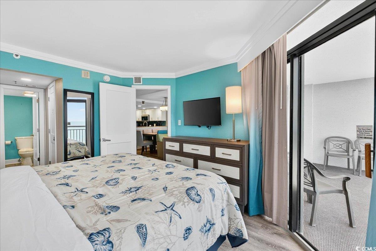 7200 North Ocean Boulevard, Unit 1155 Myrtle Beach, SC 29572 - Photo 38 of 40 Bedroom with light wood-style flooring, ornamental molding, and a closet