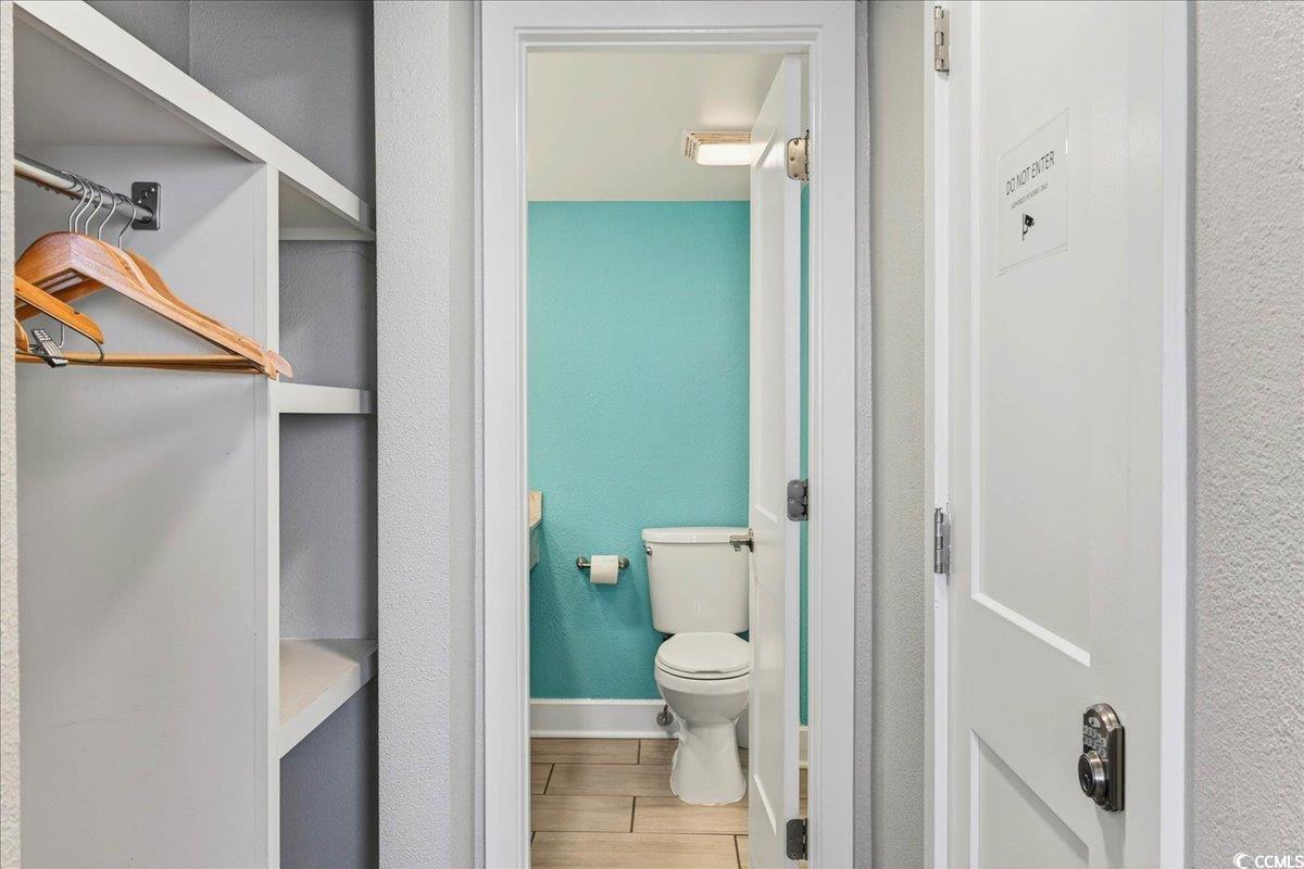 7200 North Ocean Boulevard, Unit 1155 Myrtle Beach, SC 29572 - Photo 40 of 40 Bathroom with toilet and wood finished floors