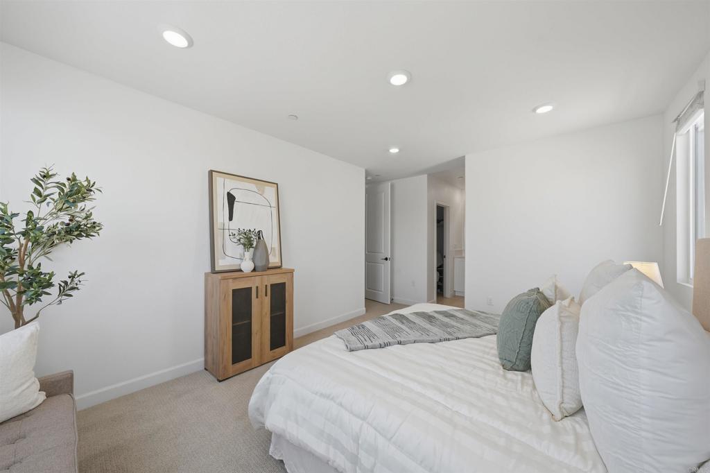 2402 Cascalote Loop San Diego, CA 92154 - Photo 20 of 35 a bedroom with a bed and a potted plant