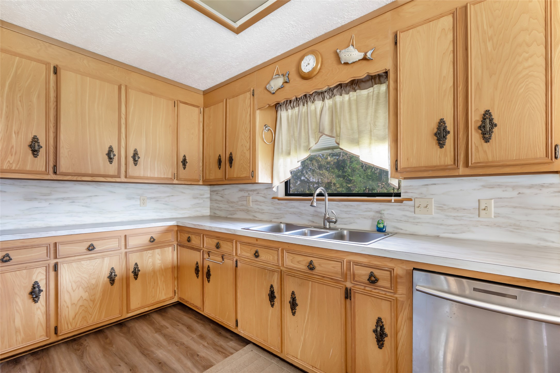 600 Sam Houston Loop Point Blank, TX 77364 - Photo 14 of 28 a kitchen with a sink dishwasher and cabinets with wooden floor