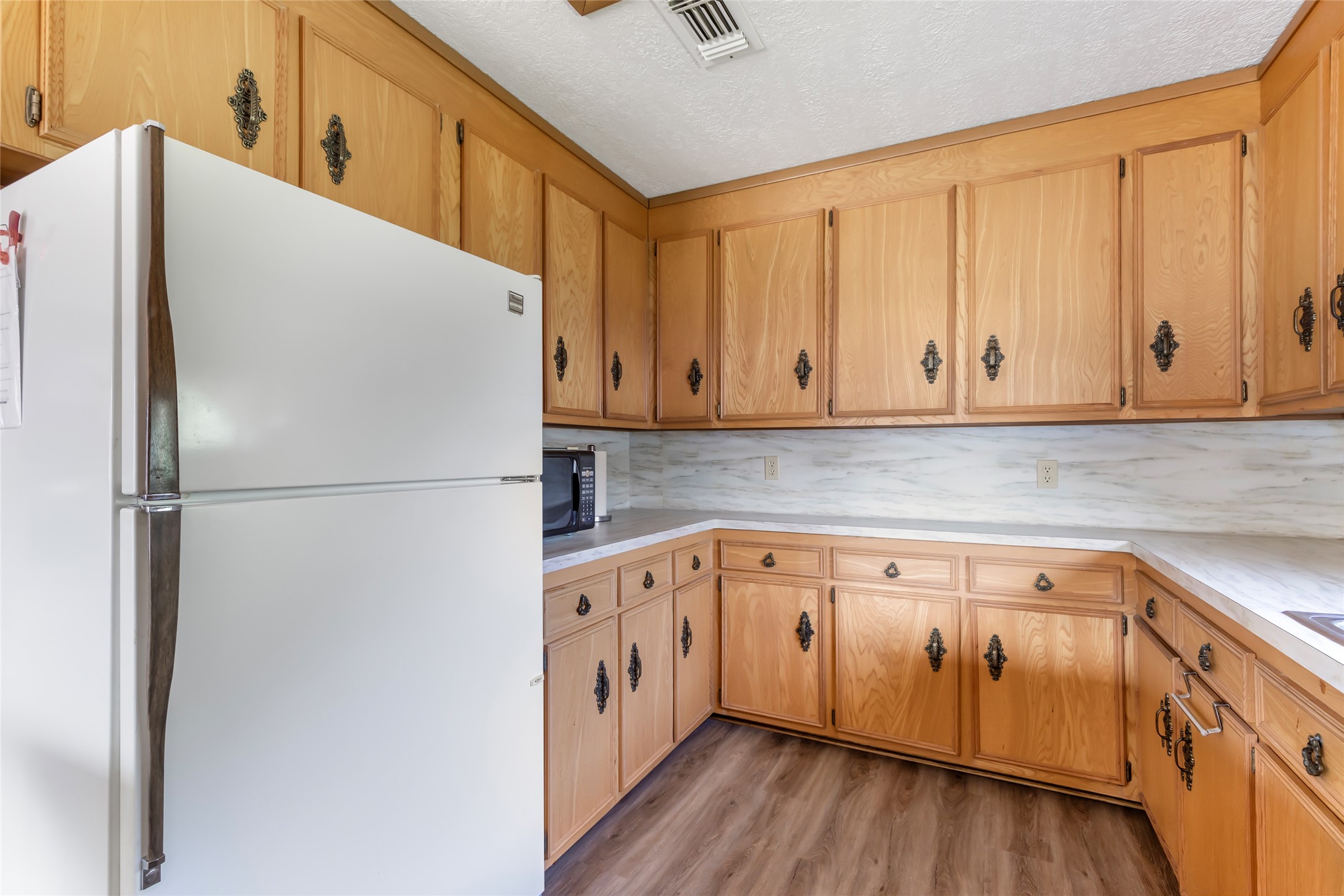 600 Sam Houston Loop Point Blank, TX 77364 - Photo 15 of 28 a kitchen with stainless steel appliances white cabinets and a refrigerator