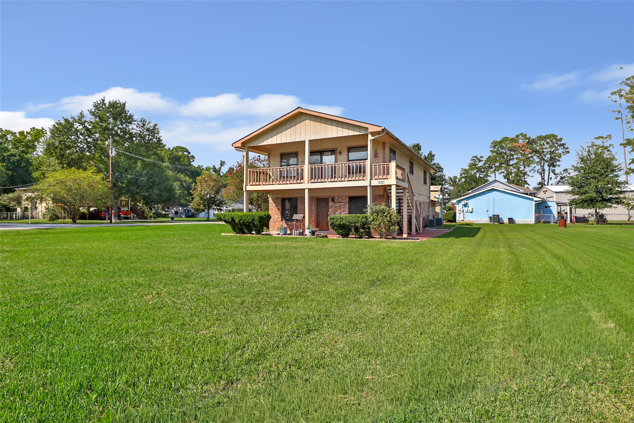 600 Sam Houston Loop Point Blank, TX 77364 - Photo 2 of 28 a view of an house with backyard and garden
