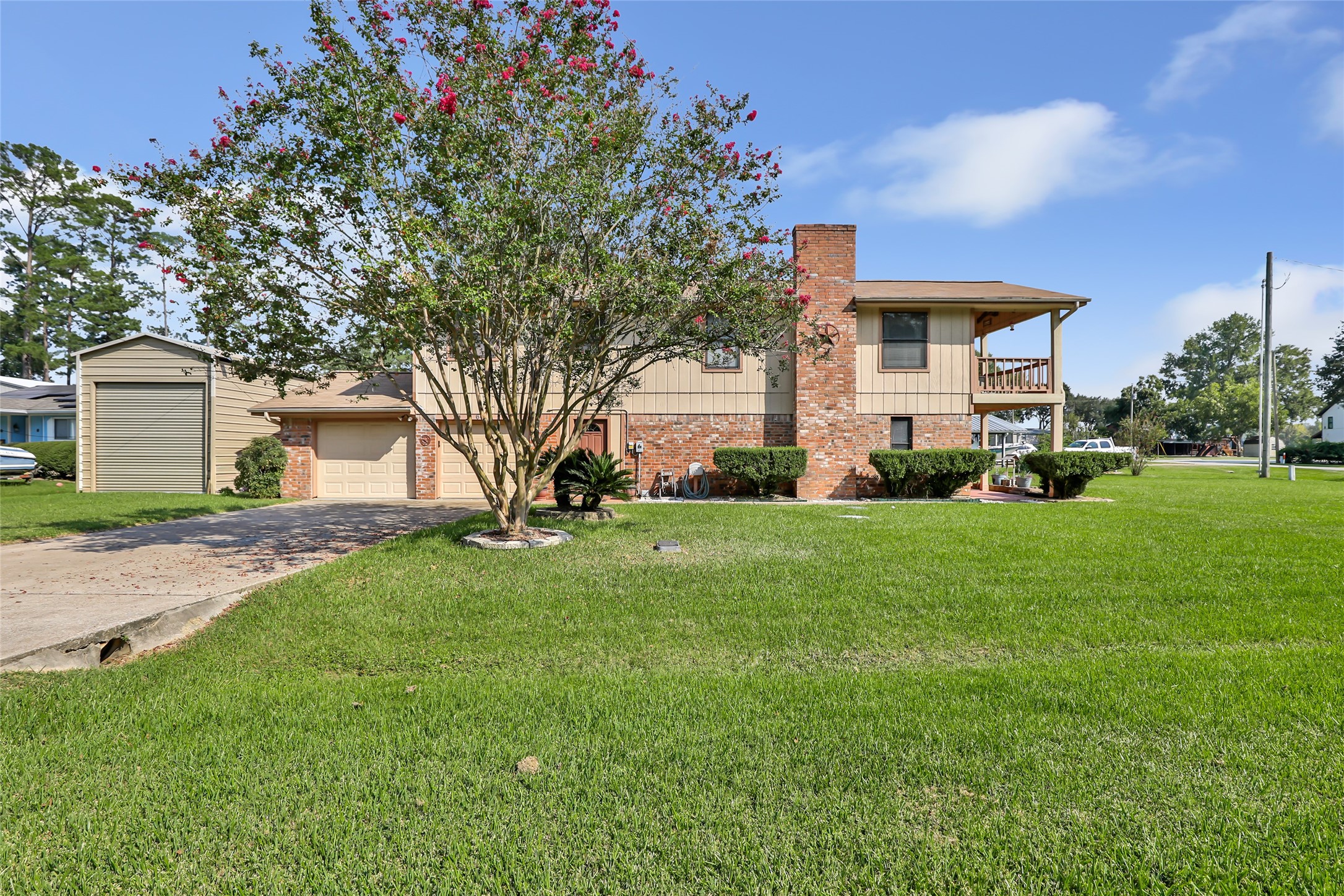 600 Sam Houston Loop Point Blank, TX 77364 - Photo 4 of 28 a front view of a house with a garden and trees