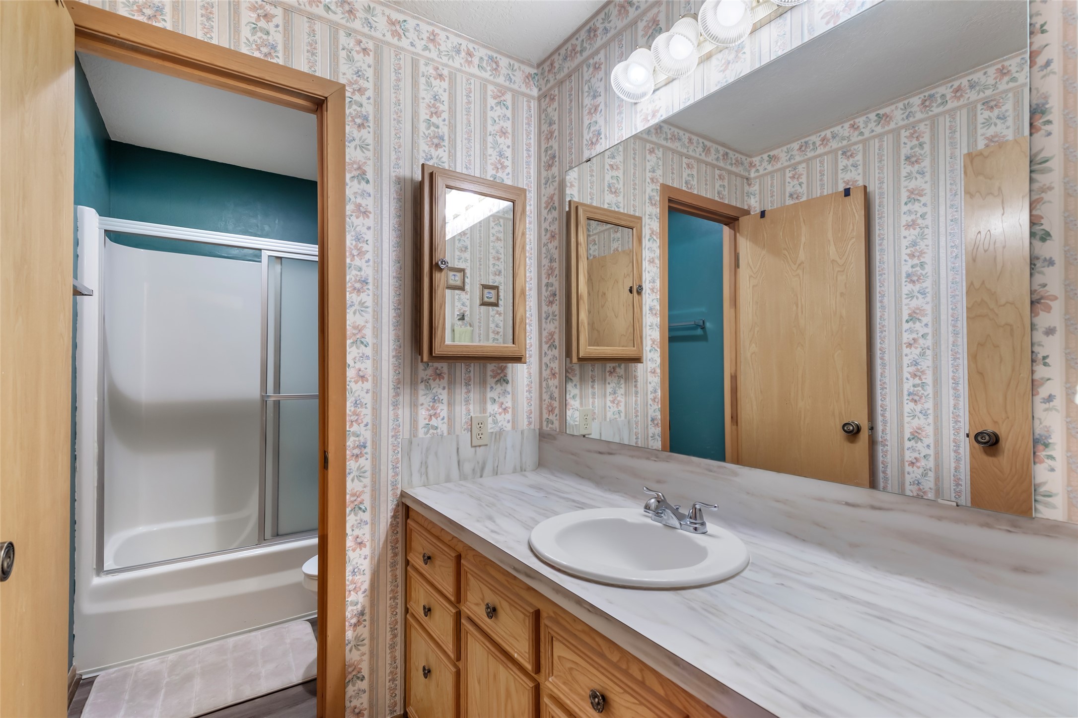 600 Sam Houston Loop Point Blank, TX 77364 - Photo 8 of 28 a bathroom with a granite countertop sink and a mirror