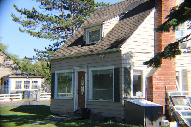 a view of a house with a yard and sitting area