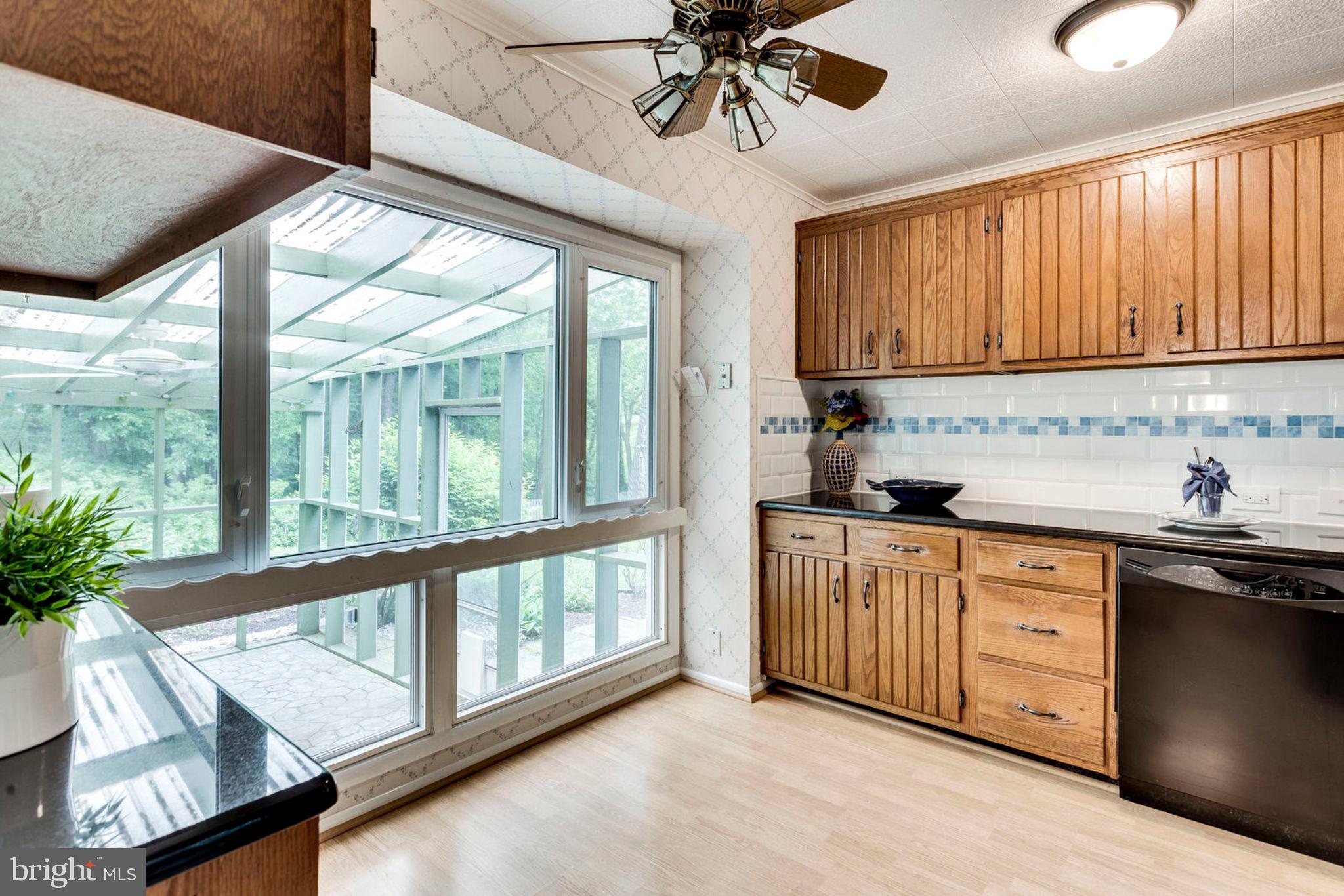 6016 Craft Road Alexandria, VA 22310 - Photo 11 of 32 a kitchen with stainless steel appliances granite countertop a stove a sink and a microwave