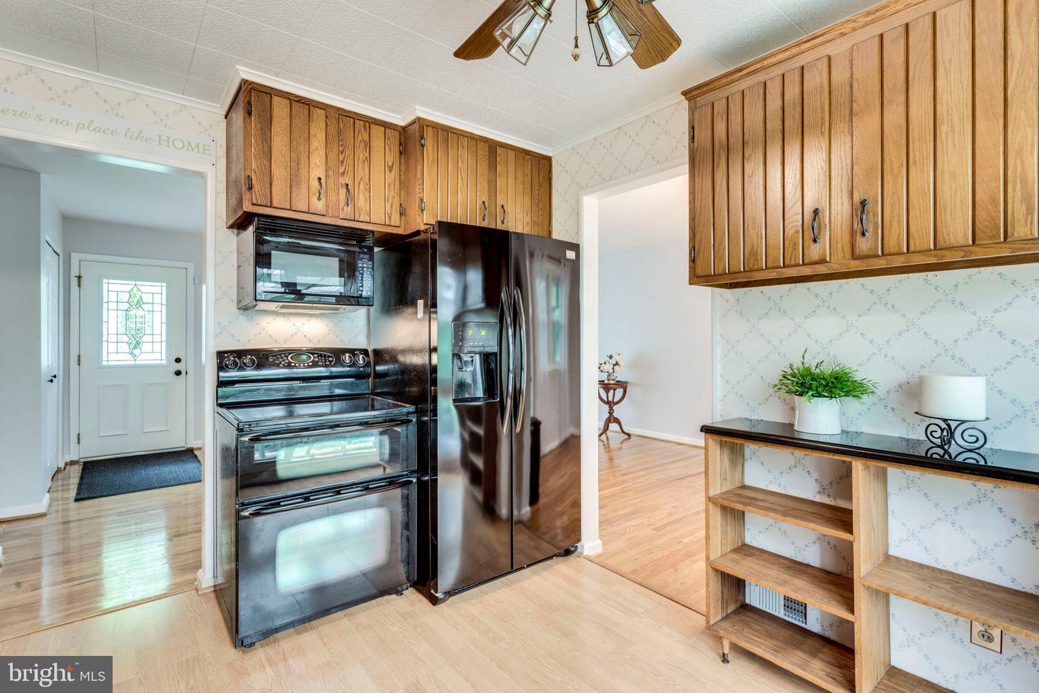 6016 Craft Road Alexandria, VA 22310 - Photo 12 of 32 a kitchen with stainless steel appliances granite countertop a refrigerator and a sink
