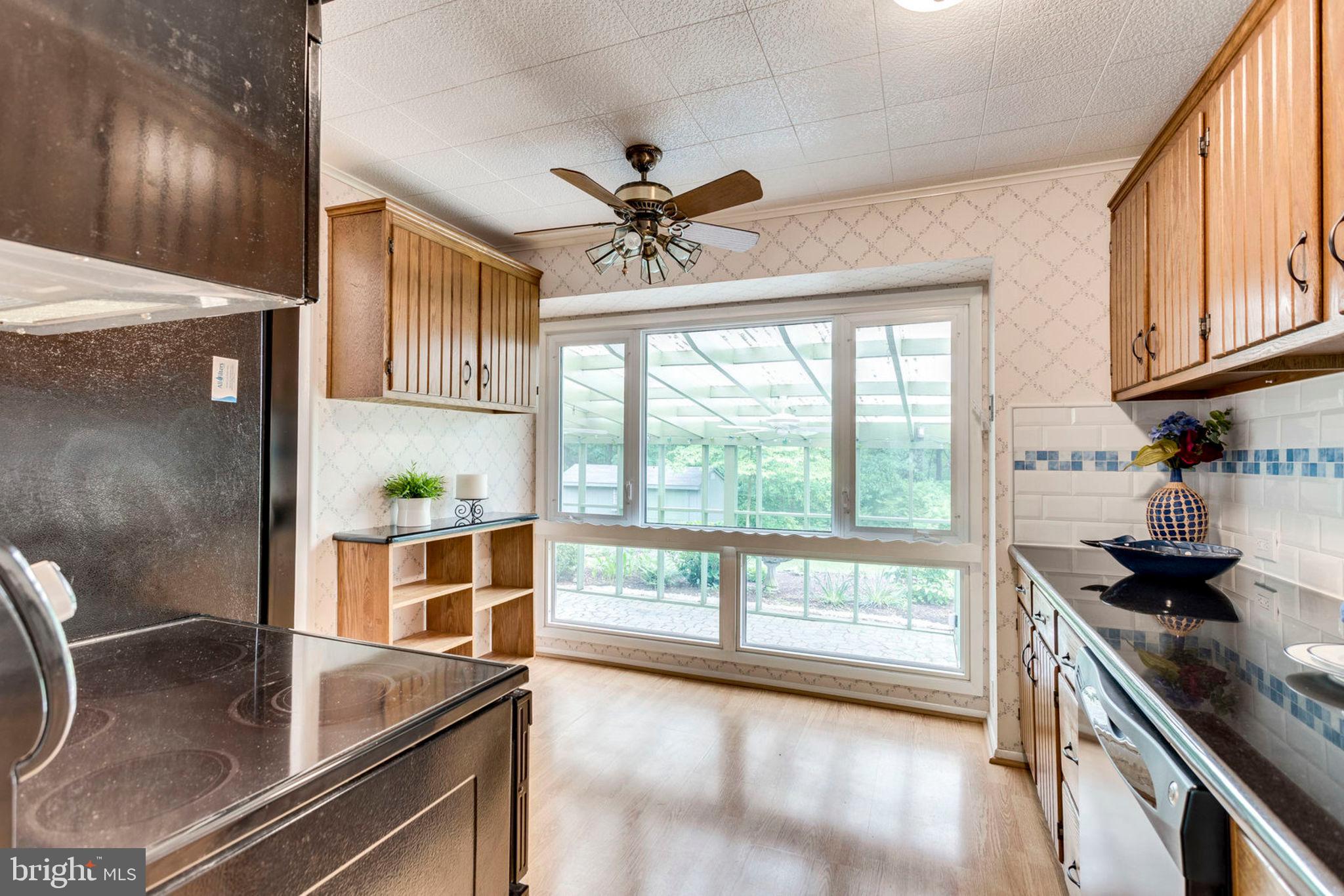 6016 Craft Road Alexandria, VA 22310 - Photo 13 of 32 a kitchen with stainless steel appliances granite countertop a stove a sink and a refrigerator