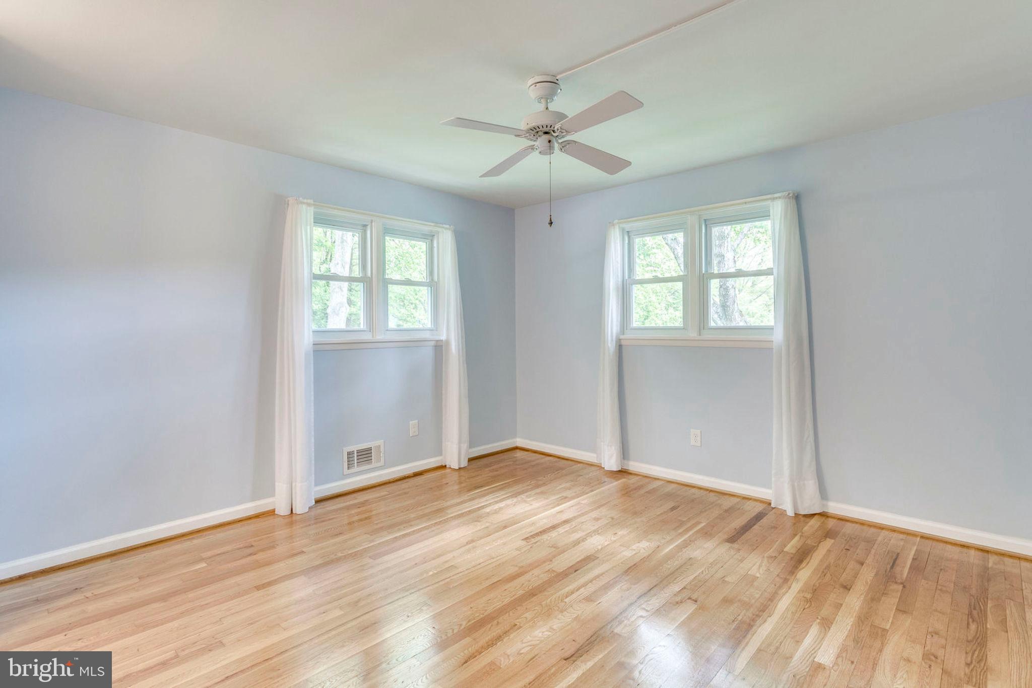 6016 Craft Road Alexandria, VA 22310 - Photo 15 of 32 a view of an empty room with wooden floor and a window