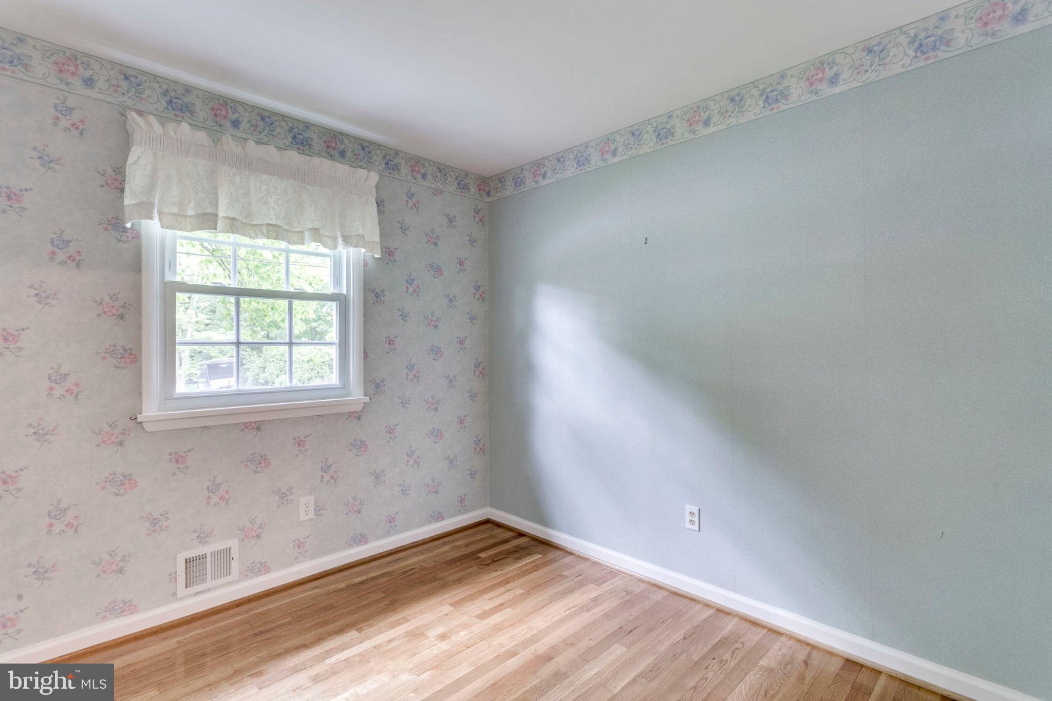 6016 Craft Road Alexandria, VA 22310 - Photo 19 of 32 a view of an empty room with wooden floor and a window