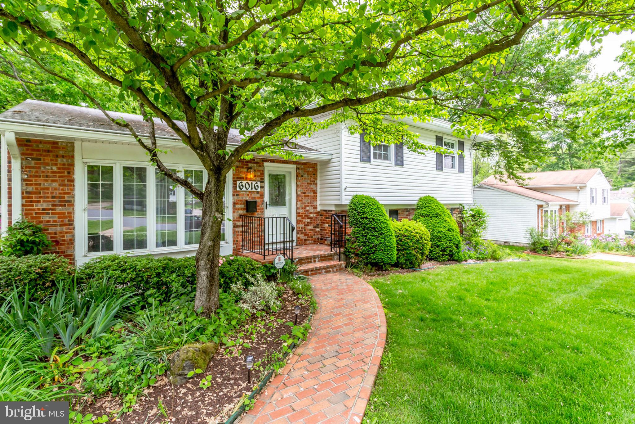 6016 Craft Road Alexandria, VA 22310 - Photo 4 of 32 a front view of a house with a yard