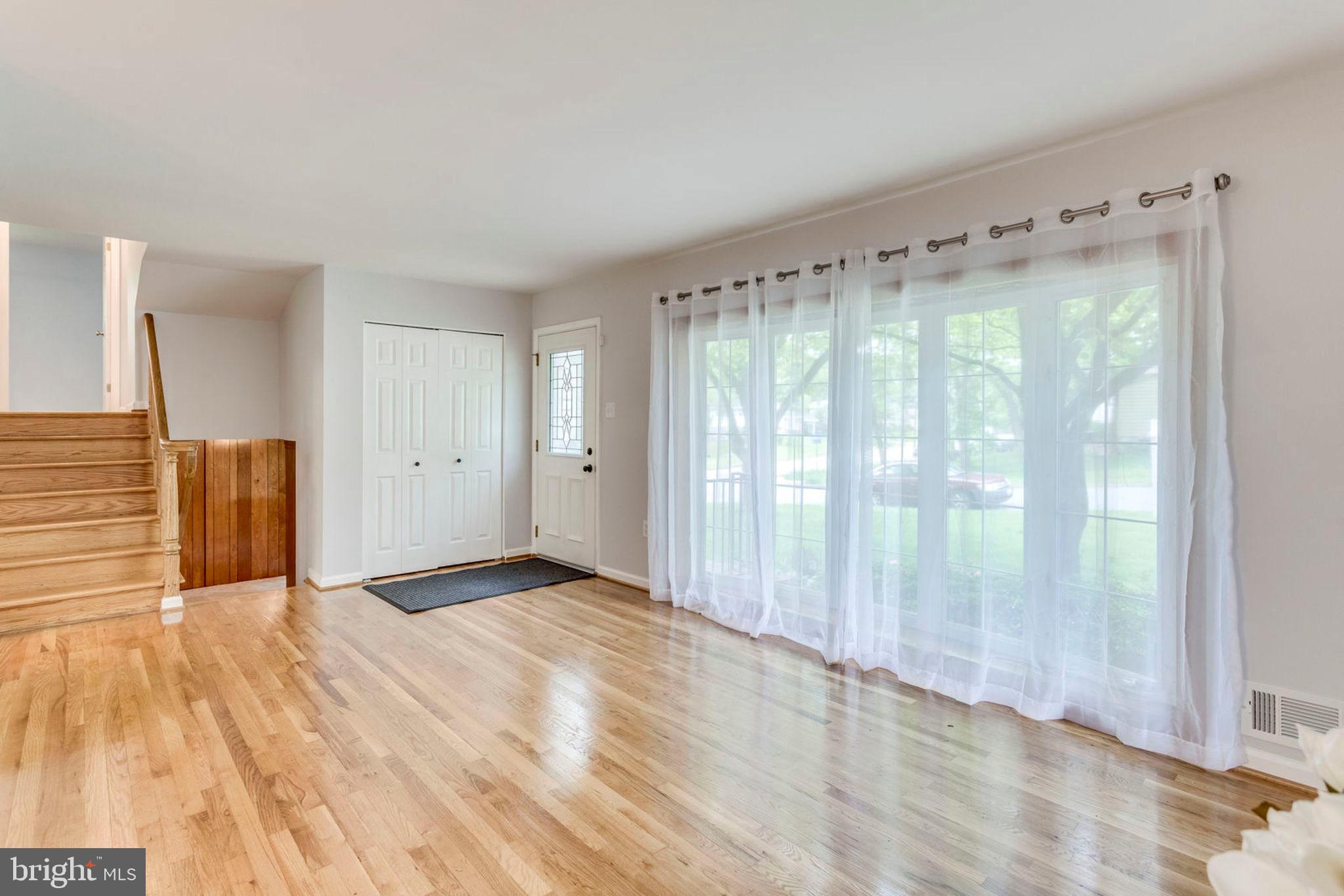 6016 Craft Road Alexandria, VA 22310 - Photo 6 of 32 a view of an empty room with wooden floor and a window