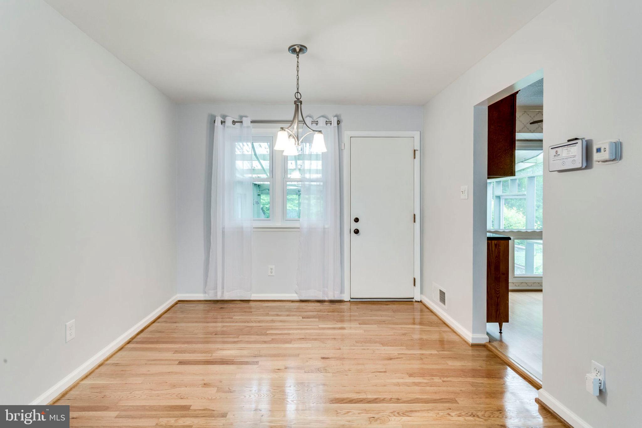 6016 Craft Road Alexandria, VA 22310 - Photo 7 of 32 a view of empty room with window and wooden floor