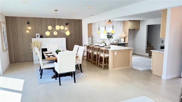 a living room with a couch and a dining table with kitchen view