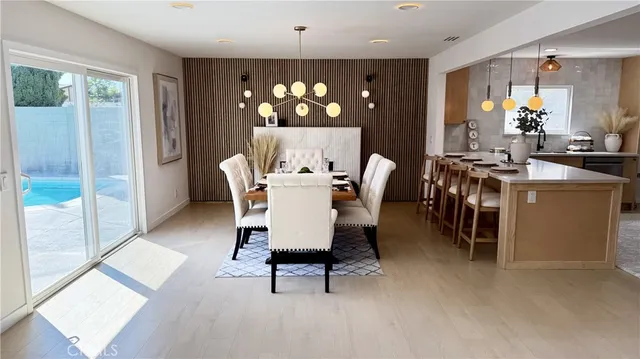 a dining room with furniture and chandelier