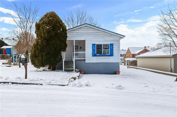 a view of a house with snow on the road