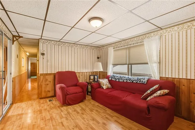 a bedroom with furniture and a large window