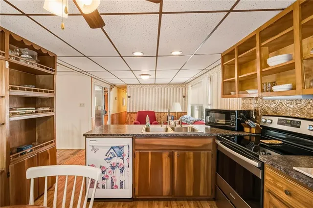 a kitchen with a stove a sink and a microwave