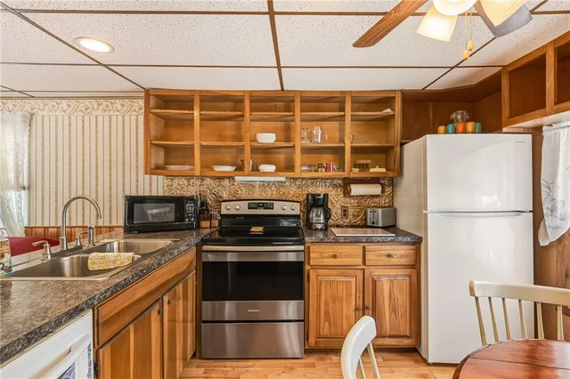 a kitchen with stainless steel appliances granite countertop a stove a refrigerator and a sink