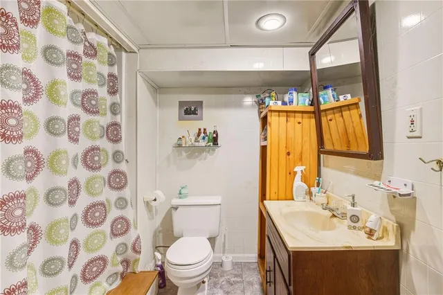 a bathroom with a sink and mirror with toilet