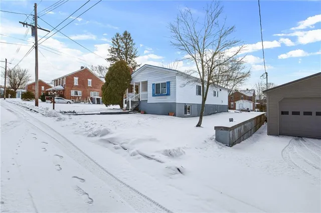a view of a house with a snow in the yard