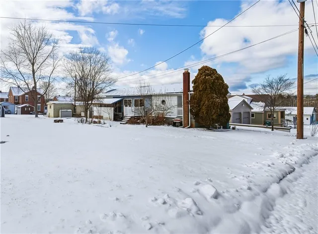 a view of a yard with snow on the road