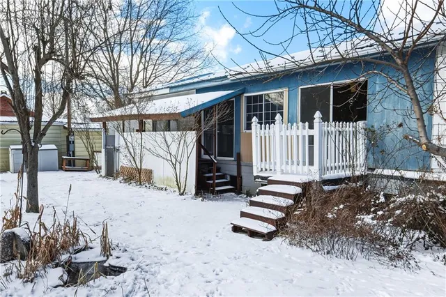 a view of a house with a yard covered in snow