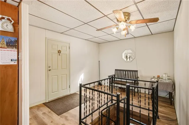 a view of entryway and hall with wooden floor