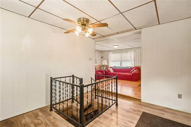 a view of a hallway with a dining table and a chandelier
