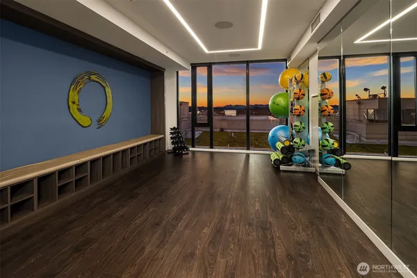 a kitchen with a refrigerator and white cabinets