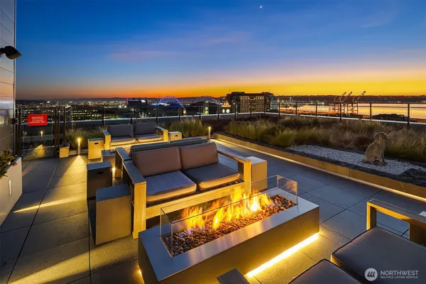 a view of a roof deck with sunset view