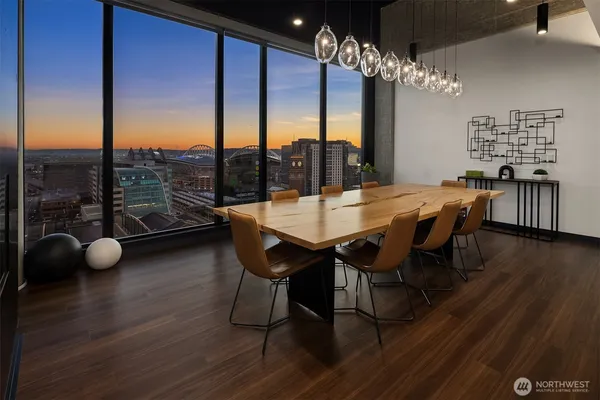 a dining room with furniture and chandelier fan