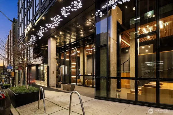 a living room with blue lights with furniture and potted plants