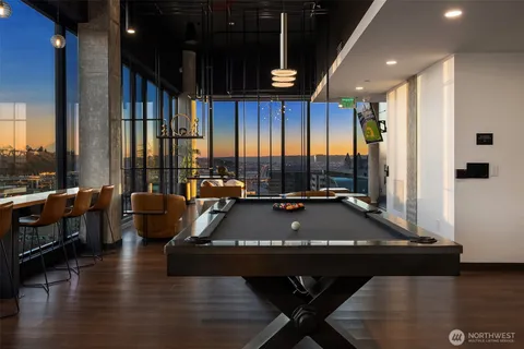 a living room with fireplace furniture and a floor to ceiling window