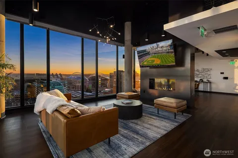 a living room with furniture and a floor to ceiling window