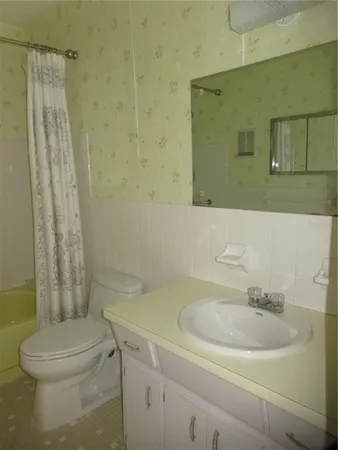 a bathroom with a toilet and shower