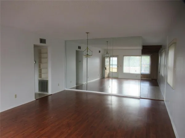 a view of a room with wooden floor and windows