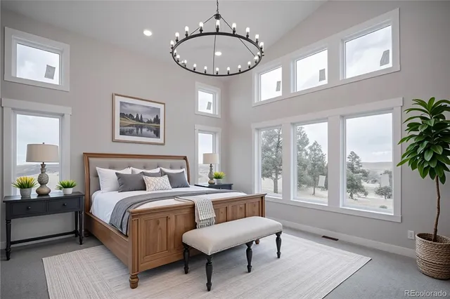 a bedroom with a bed a mirror and a large window