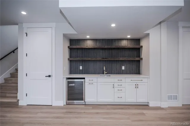 a view of cabinets a oven and a stove in a room