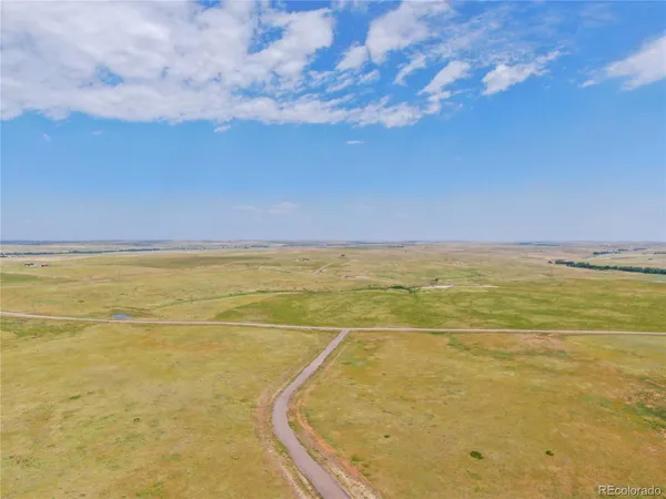 a front view of a house with a garden and parking space